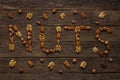 Nuts symbol as letters made with a mixed assortment of raw seeds of different nuts Royalty Free Stock Photo