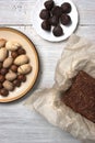 Nuts, truffle candy and chocolate cake on the white background Royalty Free Stock Photo