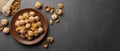 Nuts. Walnut kernels and whole walnuts on dark stone table. Royalty Free Stock Photo