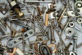 Nuts, washers, bolts, screws of various sizes and shapes over the plain background. A set for the mechanic. Royalty Free Stock Photo