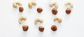 Nuts on white background as pattern, top view. Royalty Free Stock Photo