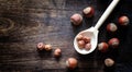 Nuts on a wooden table.Hazelnuts in the shells and shelled. A wooden spoon and nuts on a brown table Royalty Free Stock Photo