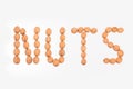 Nuts word laid out from walnuts on white background, isolated