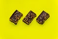 Nutty brownie bars on a yellow background