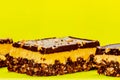 Nutty brownie bars on a yellow background. Dream bar