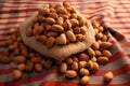 Nutty elegance Peanuts arranged tastefully on a rustic wrapping cloth Royalty Free Stock Photo