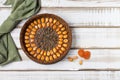 Nutty gluten-free cake with apricot nuts and pumpkin seeds  with filling  on a light wooden background. Rustic style Royalty Free Stock Photo