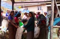 Sinhalese women waiting to get paid for their bags full with picked tea leaves