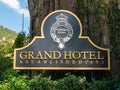 Nuwara Eliya, Sri Lanka - March 10, 2022: Close-up of a metal plaque with the name of the Grand Hotel placed near a large tree