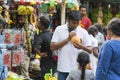 Nuwara Eliya, Sri Lanka: 03/20/2019: Traditional fruit and veg shop, man drinking from king coconut