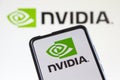 Nvidia logo of the software company which designs graphics processing units GPU on a mobile phone and computer screen