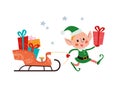 Cute little Santa elf character with sleigh full of gift boxes and presents isolated. Royalty Free Stock Photo