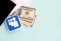 Myspace paper logo lies with envelope full of dollar bills and smartphone