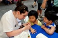 NYC: Artist Painting Child's Hand at Chinatown Festival