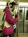 Girl on subway with cow hat