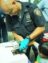 NYC Police finger printing a child for Safe card program Royalty Free Stock Photo