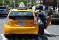 NYC: Woman Entering Yellow Taxi