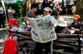 NYC: Woman Reading Chinese Newspaper