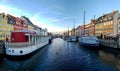 Nyhavn waterfront, canal, colorful facades of old house reflection, and buildings, ships, yachts and boats in Copenhagen, Denmark Royalty Free Stock Photo