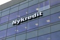 Nykredit sign on a wall on glass buildin