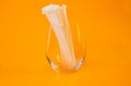 nylon cable ties in glass in jar in bucket on orange background