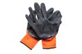 Nylon orange work gloves with black latex coating lying on top of each other with the working side up.