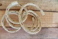 Nylon ship ropes tied in a circle on wooden background closeup.