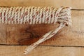 Nylon ship ropes tied to knot with copy space isolated on wooden background closeup.