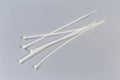 Nylon unfastened translucent cable ties on a gray background Royalty Free Stock Photo