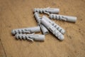 Nylon wall plugs for fastening to masonry on plywood background in workshop. Dowels.