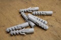 Nylon wall plugs for fastening to masonry on plywood background in workshop. Dowels. II