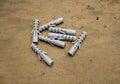 Nylon wall plugs for fastening to masonry on plywood background in workshop. Dowels.