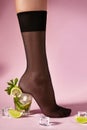 Nylons, stay-up, tights, hosiery, hose, pantyhose socks summer collection on pink background as a heel creative a glass of