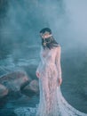 Nymph, walks in the river which was tightened by a thick, impenetrable fog. She has a white vintage, lacy dress. Feast Royalty Free Stock Photo