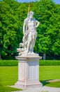 Nymphenburg, Germany - July 30, 2015: Neptun sculpture, king of the seas, beautiful sunny day, green grass and bushes in