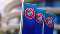 Three vertical banners with UEFA logo waving in the wind