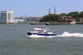 NYPD boat patrolling New York Harbor in the front of Governors Island Royalty Free Stock Photo