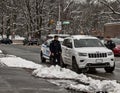 NYPD New York City police officers stop a driver on Empire Boulevard, Brooklyn, NYC during winter Royalty Free Stock Photo