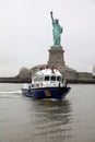 NYPD Patrolling Boat in front of the Statue of Liberty. New York City