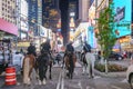 NYPD police officers on horseback in Times Square, New York City. Mounted Police patrolling the night in Times Square Royalty Free Stock Photo
