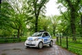 NYPD police Smart Fortwo small patrol car parked on green alley at Central Park. - New York, USA - 2021