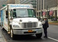 NYPD traffic control officer writing parking violation in Midtown Manhattan