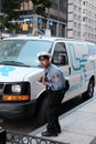 NYPD traffic officer seen issuing a parking ticket in New York City, Royalty Free Stock Photo