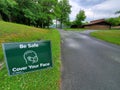 NYS Parks and Recreation yard sign in clover grass to cover face with mask