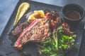 NZ ribeye steak, pan seared to medium rare, accompanied with real country creamy mashed potato, cherry tomatoes on vine, garden Royalty Free Stock Photo