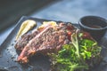 NZ ribeye steak, pan seared to medium rare, accompanied with real country creamy mashed potato, cherry tomatoes on vine, garden Royalty Free Stock Photo