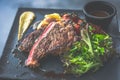 NZ ribeye steak, pan seared to medium rare, accompanied with real country creamy mashed potato, cherry tomatoes on vine, garden Royalty Free Stock Photo