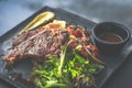 NZ ribeye steak, pan seared to medium rare, accompanied with real country creamy mashed potato, cherry tomatoes on vine, garden Royalty Free Stock Photo