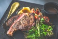 NZ ribeye steak, pan seared to medium rare, accompanied with real country creamy mashed potato, cherry tomatoes on vine, garden Royalty Free Stock Photo