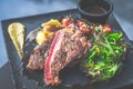 NZ ribeye steak, pan seared to medium rare, accompanied with real country creamy mashed potato, cherry tomatoes on vine, garden Royalty Free Stock Photo